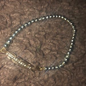 a bracelet that has feather in middle
